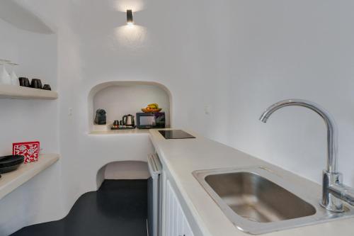 a kitchen with a sink and a counter top at Alba Caverns in Fira