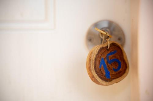 a lock on a door with a clock on it at Neot Semadar Eco Lodge in Naẖal Ya‘alon
