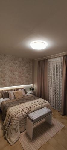 a bedroom with a large bed with a bench in it at casa vacanza sussurro dei venti in Catanzaro