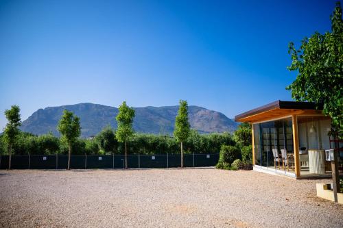 a pavilion with mountains in the background at Olivia La Casa sul fiume in Terracina
