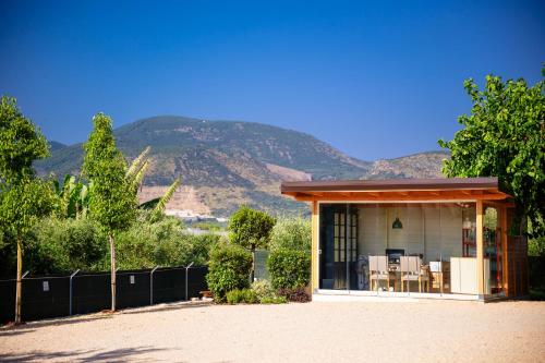 a small house with mountains in the background at Olivia La Casa sul fiume in Terracina