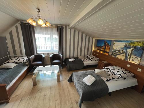 a living room with two beds and a couch at AbWentur Pokoje in Gdańsk