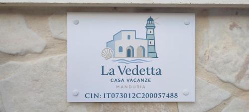 a sign on a wall with a lighthouse at La vedetta in San Pietro in Bevagna