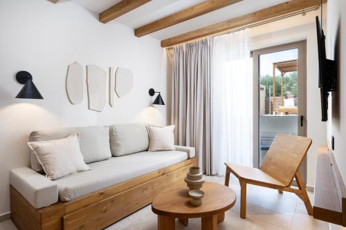 a living room with a couch and a chair at Aegean Houses in Kos Town