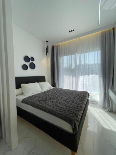 a bedroom with a large bed with a window at Studio102 in Naama bay in Sharm El Sheikh