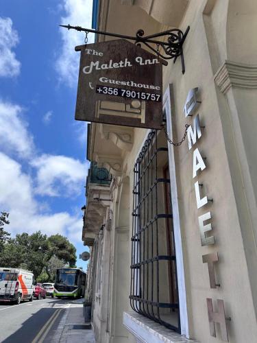 a sign for a restaurant on the side of a building at Maleth Inn in Rabat