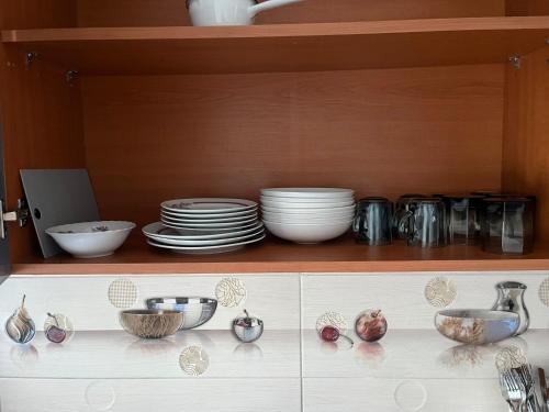 a shelf with plates and bowls and dishes on it at Casa Primaverii in Râşnov