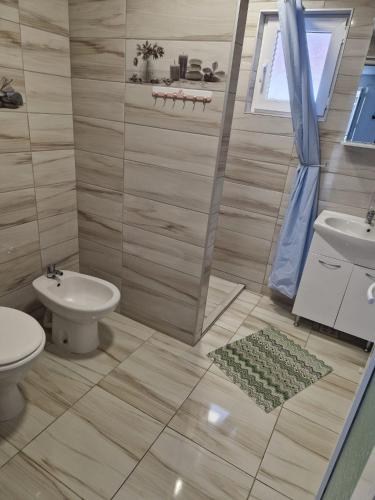 a bathroom with a toilet and a sink at Casa Andreea in Corbu
