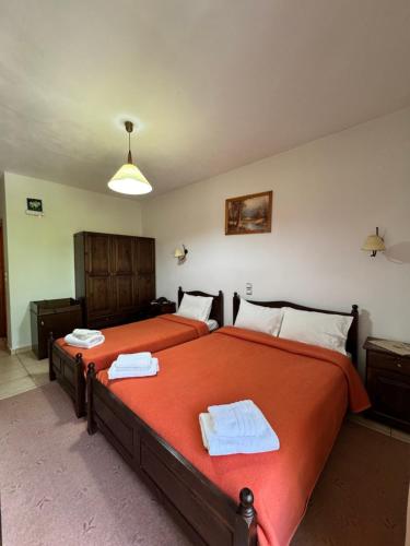a bedroom with two beds with towels on them at Archontiko tou Krommyda in Elati Trikalon