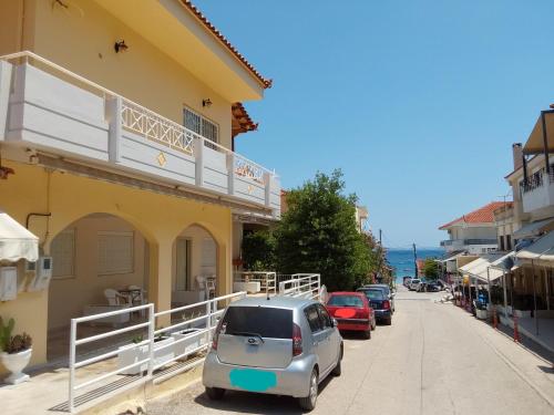 a small car parked on a street next to a building at Vasiliki Studios Tolo in Tolo