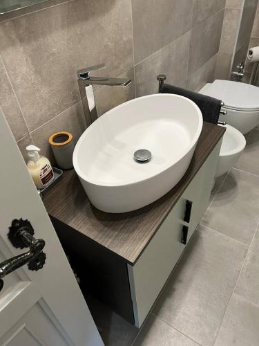 a bathroom with a white sink and a toilet at Un rifugiio a Salice d'Oulx in Sauze d'Oulx