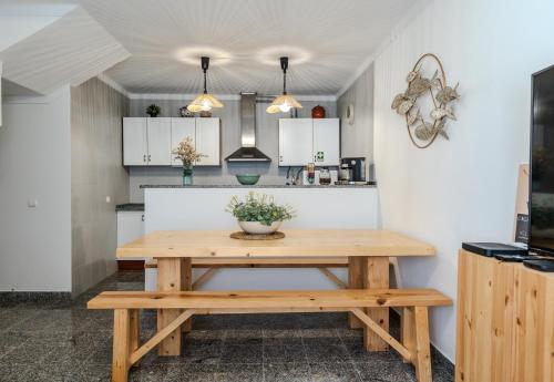 a kitchen with a wooden table in a kitchen at Casa dos Rosas in Melides