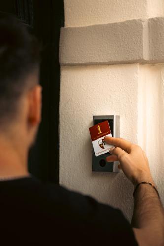 a man is putting a card on a lightswitch at La Dimora del Generale in Pizzo