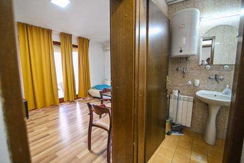 a room with a bathroom with a sink and a mirror at VN APARTMENTS OHRID in Ohrid