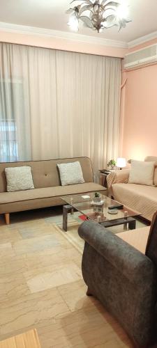 a living room with a couch and a coffee table at 3 Brothers IV in Tríkala