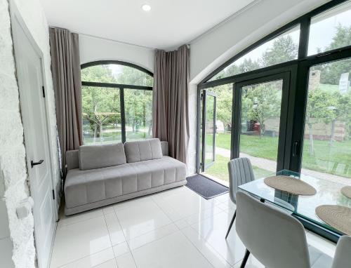 a living room with a couch and a table at Raduga Orion villa in Chon-Sary-Oy
