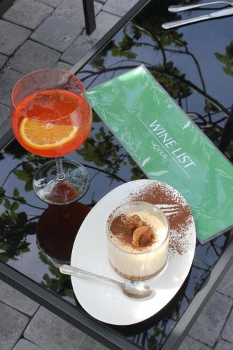 a table with a plate of dessert and a drink at Hover Boutique Hotel in Dilijan