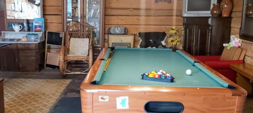 a living room with a pool table in it at Dom Pod Gruszą in Chmielno