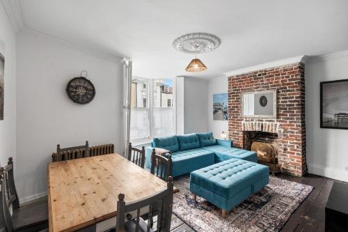 a living room with a couch and a table at Three Bedroom Townhouse by Primal Estates Short Lets in Brighton in Brighton & Hove
