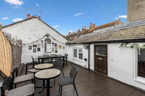 a patio with tables and chairs and a building at Three Bedroom Townhouse by Primal Estates Short Lets in Brighton in Brighton & Hove