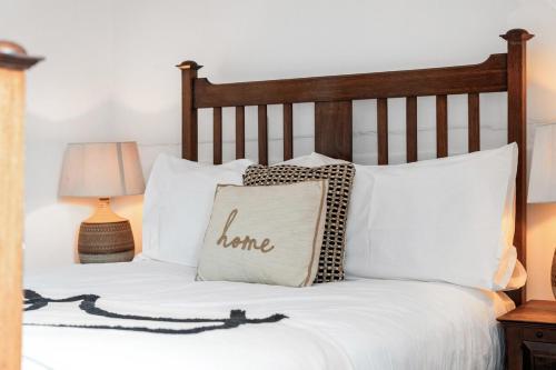 a bed with a pillow with the word home on it at Three Bedroom Townhouse by Primal Estates Short Lets in Brighton in Brighton & Hove