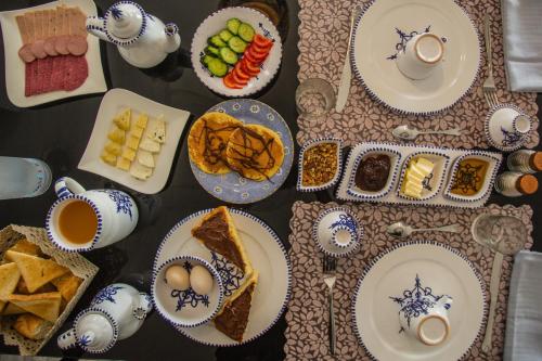 a table topped with plates of food and bowls of food at Dar Lina "Charme et nature" in El Haouaria
