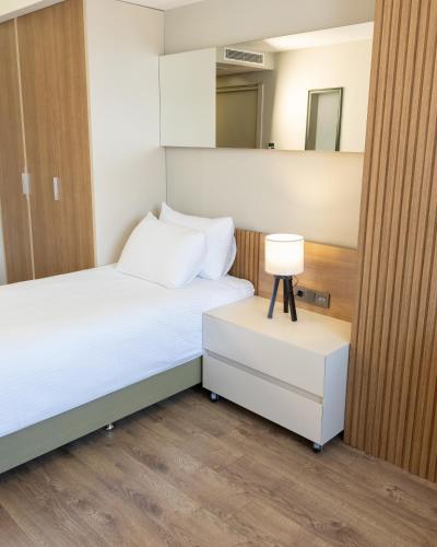a bedroom with a bed and a lamp on a night stand at Frezya - Exclusively Woman in Istanbul
