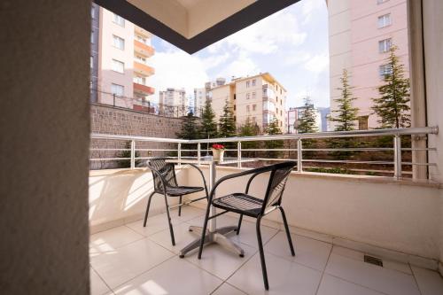 a balcony with two chairs and a table on a balcony at ARGEUS PRESTİJ in Kayseri