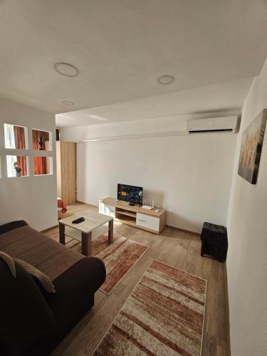 a living room with a couch and a tv at Apartman Annie in Bihać