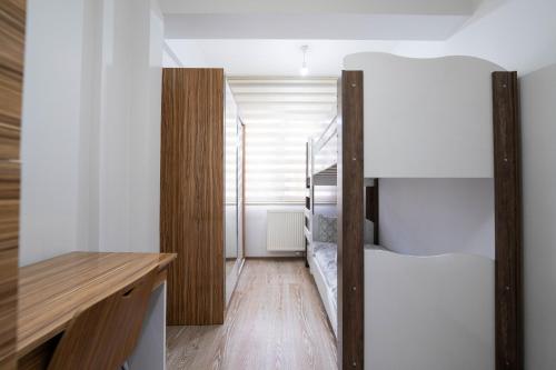 a bedroom with a bunk bed and a desk at ARGEUS PRESTİJ in Kayseri
