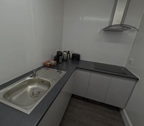 a kitchen with a sink and a counter top at Ellan Vannin Hotel in Douglas