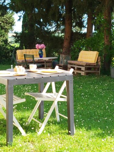 a picnic table in the grass with flowers on it at Il Parco in Ancona