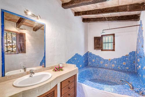 a bathroom with a sink and a blue tile tub at Son Del Rio Nou in Pollença