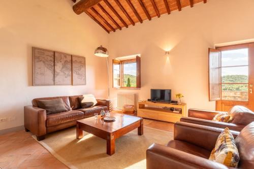 a living room with leather furniture and a coffee table at Minimal & Modern Home - In Arceno Estate in Villa dʼArceno