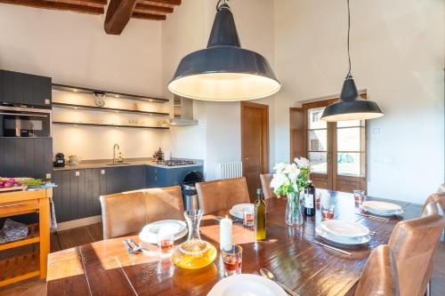 a kitchen and dining room with a wooden table at Minimal & Modern Home - In Arceno Estate in Villa dʼArceno