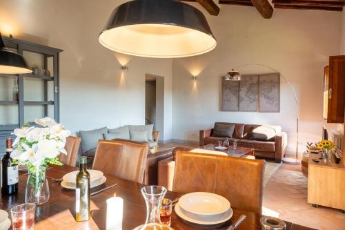 a living room with a table and a couch at Minimal & Modern Home - In Arceno Estate in Villa dʼArceno