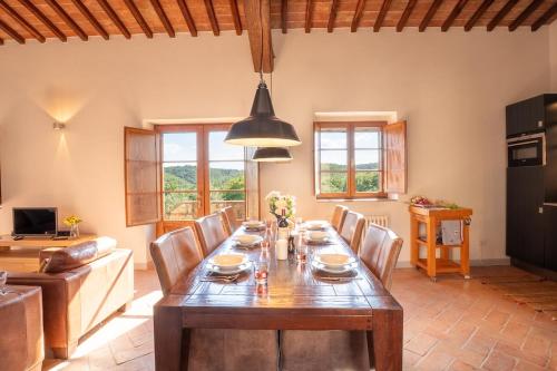 a living room with a wooden table and chairs at Minimal & Modern Home - In Arceno Estate in Villa dʼArceno