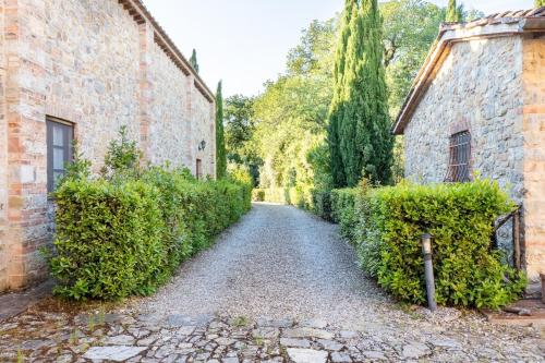a cobblestone alley between two stone buildings at Minimal & Modern Home - In Arceno Estate in Villa dʼArceno