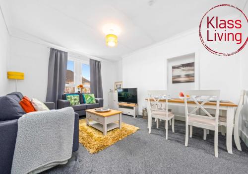 a living room with a couch and a table at Broomfield Apartment by Klass Living Airdrie in Airdrie