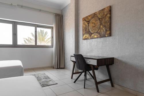 a bedroom with a desk and a bed and a desk at Simply Comfort Vacation Homes Rental Luxury Beachfront Villa with Private Pool on Palm Jumeirah near Atlantis in Dubai