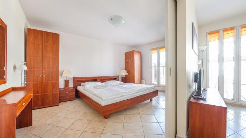 a bedroom with a bed and a tv in it at Promenada I, Sun & Snow in Świnoujście