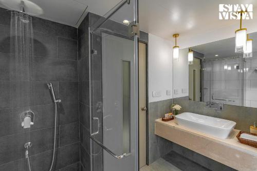 a bathroom with a shower and a sink at StayVista at Villa Holiva with Pool, Beach View in Silidao