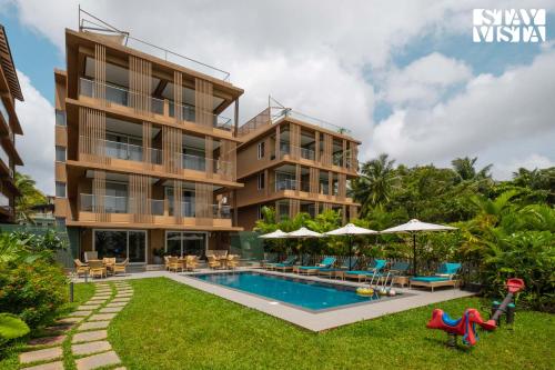 an image of a villa with a swimming pool at StayVista at Villa Holiva with Pool, Beach View in Silidao