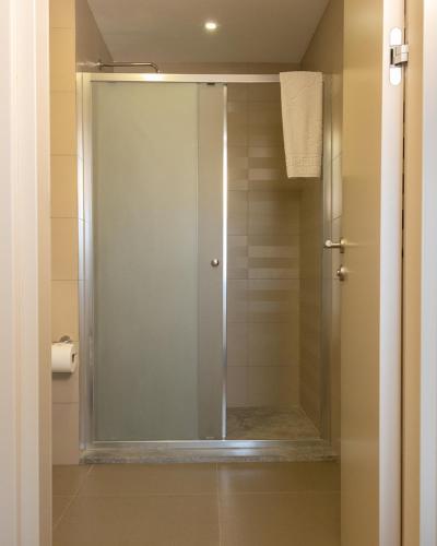 a shower with a glass door in a bathroom at Frezya - Exclusively Woman in Istanbul