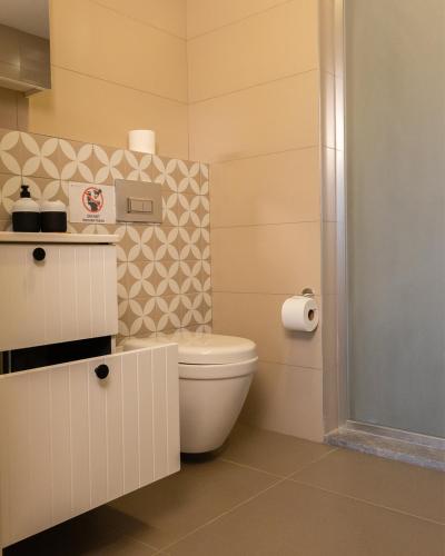 a bathroom with a white toilet in a room at Frezya - Exclusively Woman in Istanbul