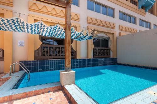 a swimming pool in the middle of a building at Simply Comfort Vacation Homes Rental Luxury Beachfront Villa with Private Pool on Palm Jumeirah near Atlantis in Dubai