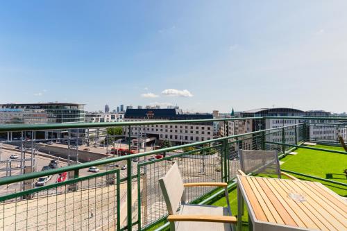 a balcony with a table and chairs and a city at Pension Petit in Bratislava