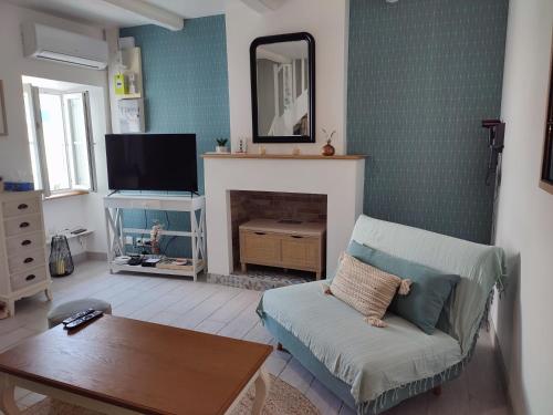 a living room with a couch and a fireplace at Maison de vacances ile d'Oléron 4 pers à St Denis proche plage in Saint-Denis-dʼOléron