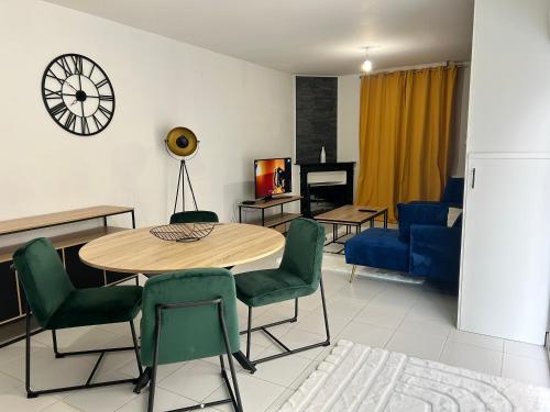 un salon avec une table, des chaises et un canapé dans l'établissement La Perle Rive Gauche, au Mans
