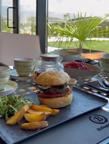a sandwich on a table with a plate of food at Yssyk-kul Palm in Chok-Tal